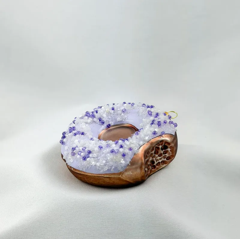 Donut mit lila Zuckerguss und lila Streusseln
