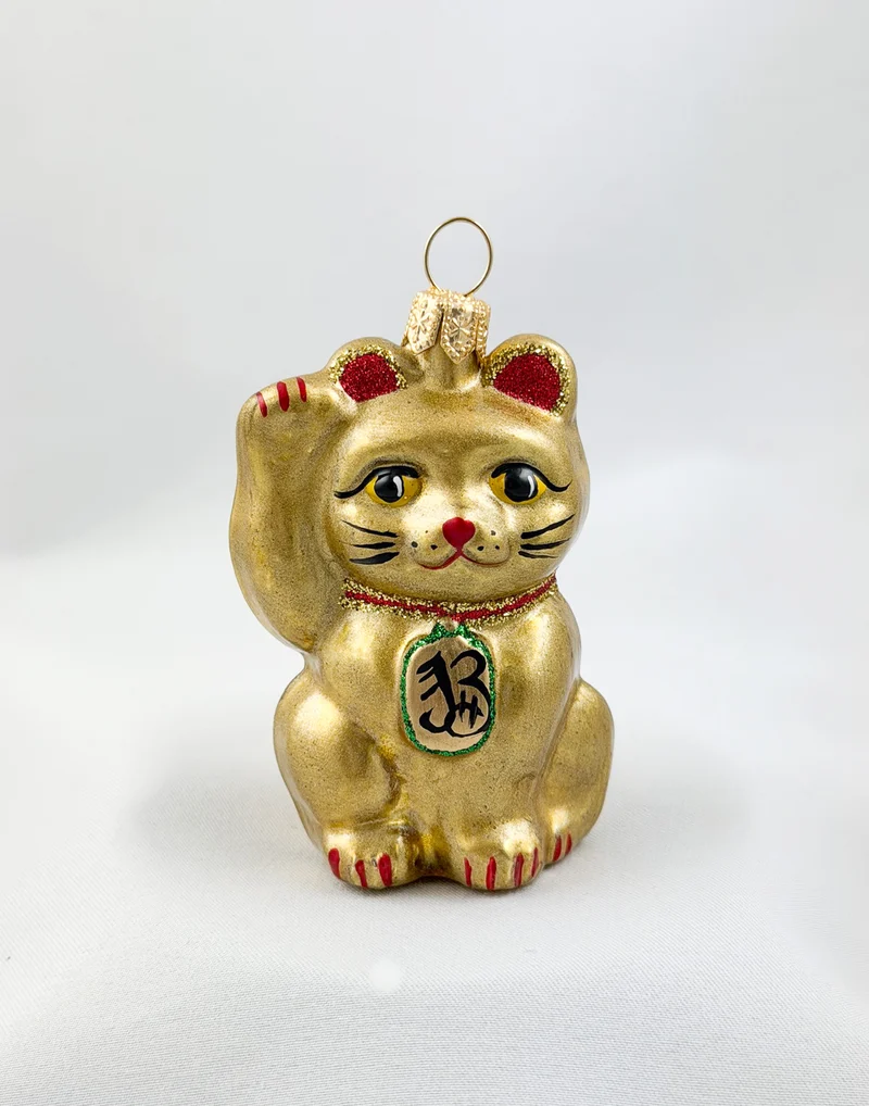 Kleine goldene Maneki-Neko, asiatische Glückskatze