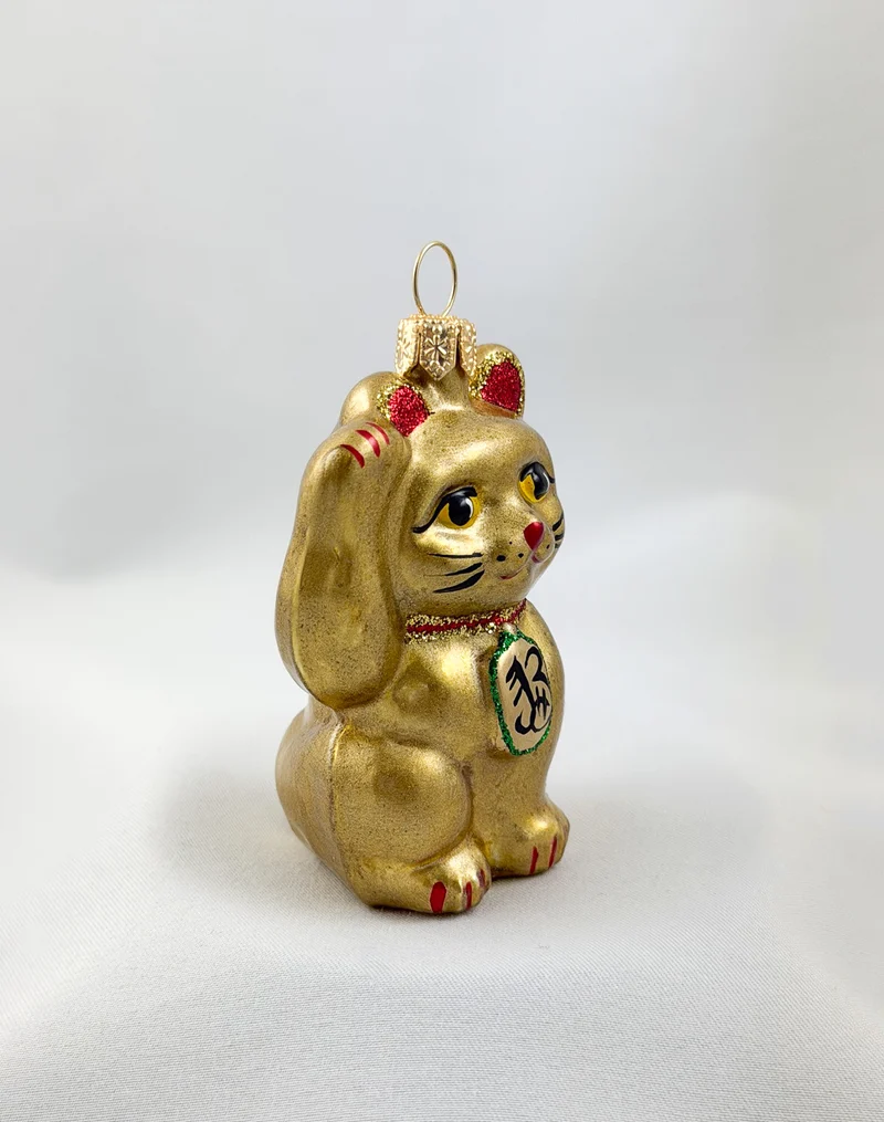Kleine goldene Maneki-Neko, asiatische Glückskatze