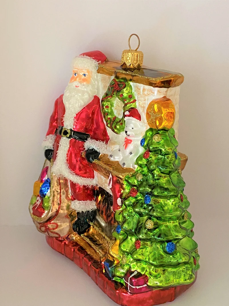Santa Claus wärmt sich am Kaminfeuer auf