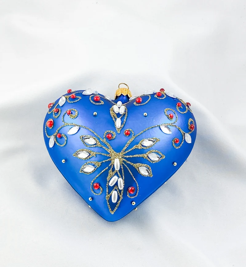 Blaues Herz mit Perlen und roten Schmucksteinen