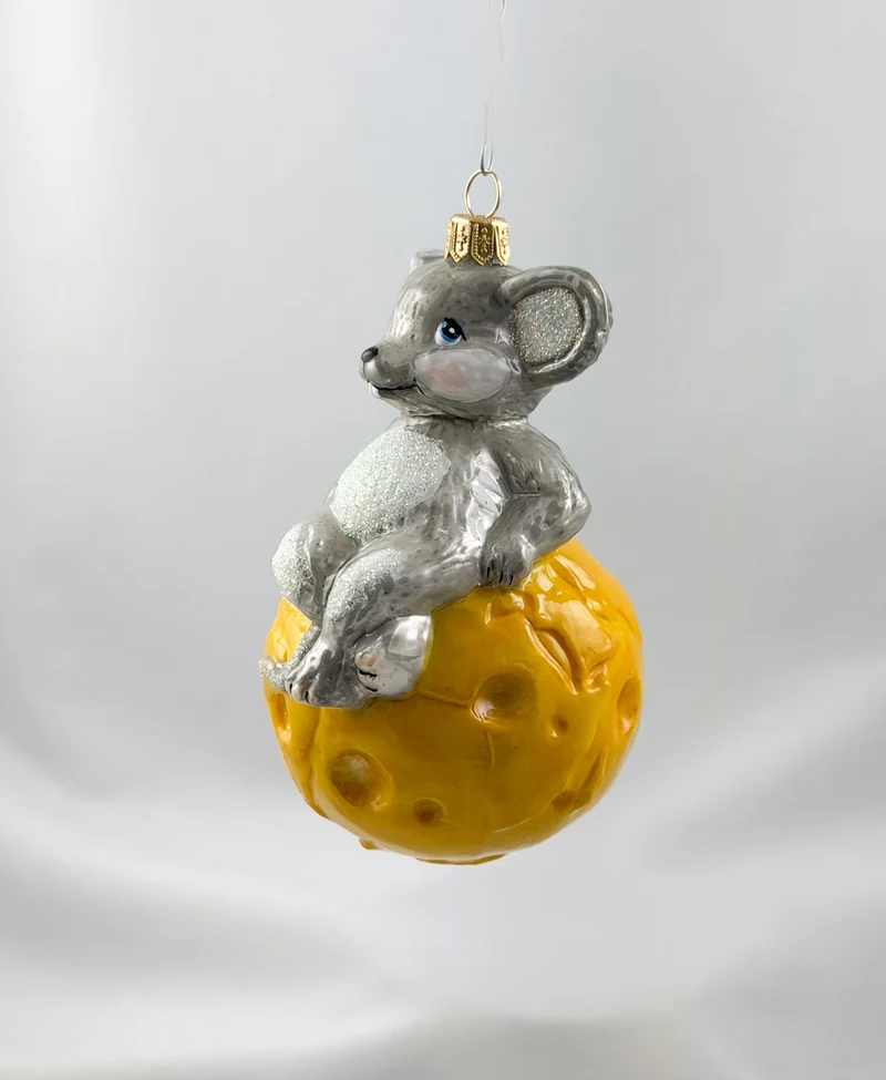 Die Maus sitzt gemütlich auf dem Käse-Globus