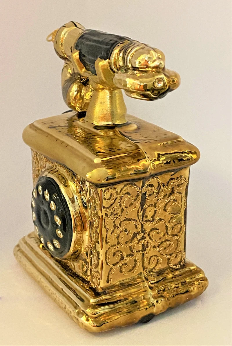 Nostalgisches Telefon antikgold mit schwarzer Wählscheibe