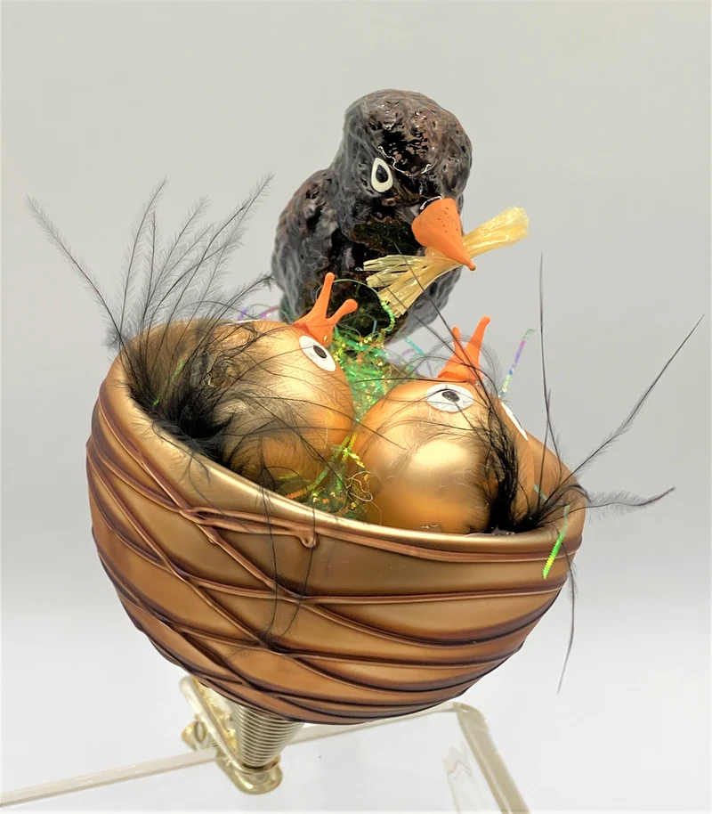 Die Amsel füttert die Jungen im Nest