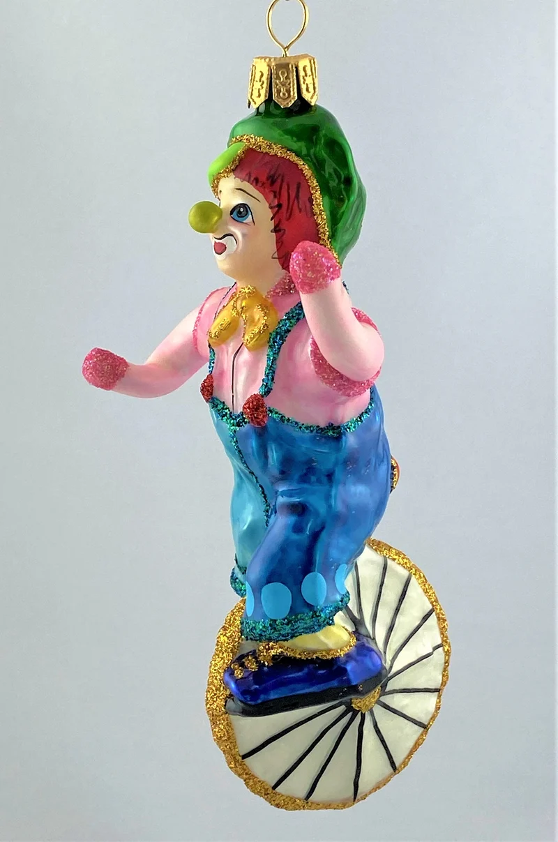 Clown im rosa Hemd fährt Einrad