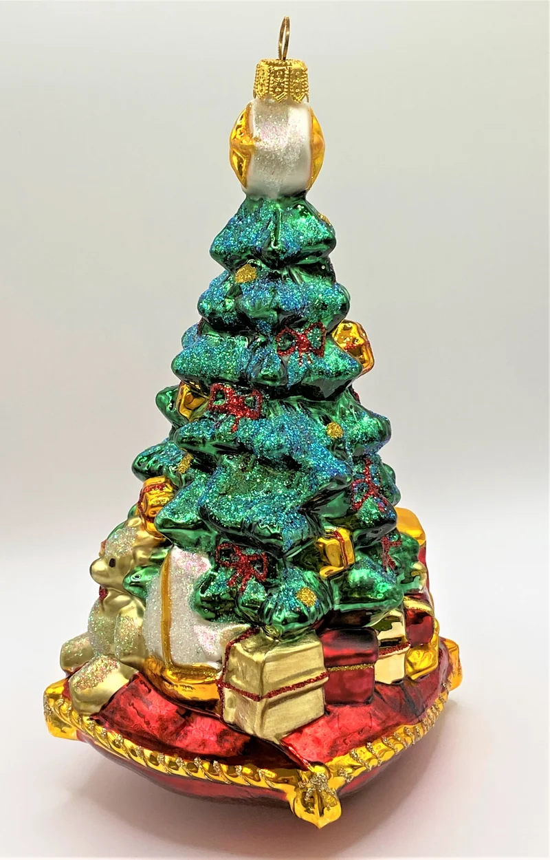 Christbaum mit Teddybär, Lokomotive und Segelboot auf Kissen