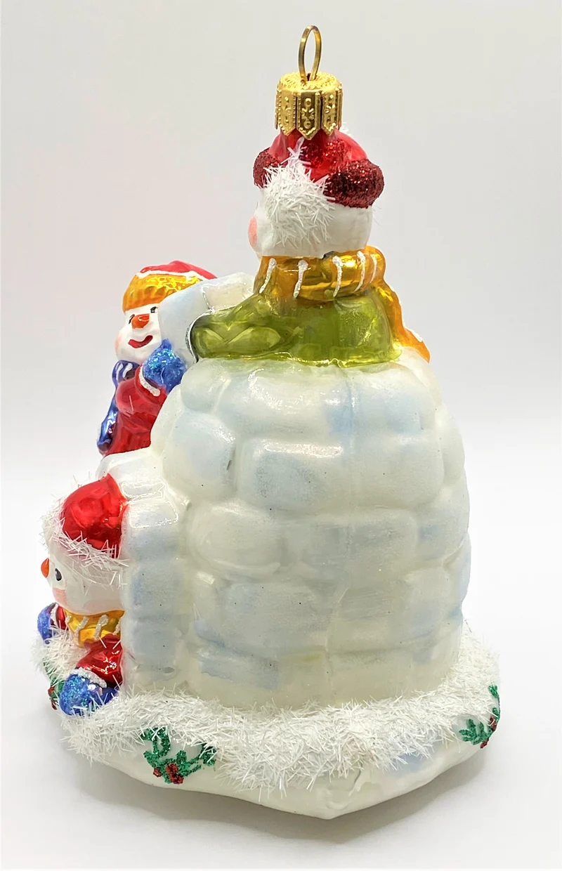 Drei Schneemänner bauen sich ein Iglu