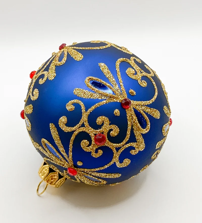 Kugel blau matt mit Golddekor und kleinen roten Steinen
