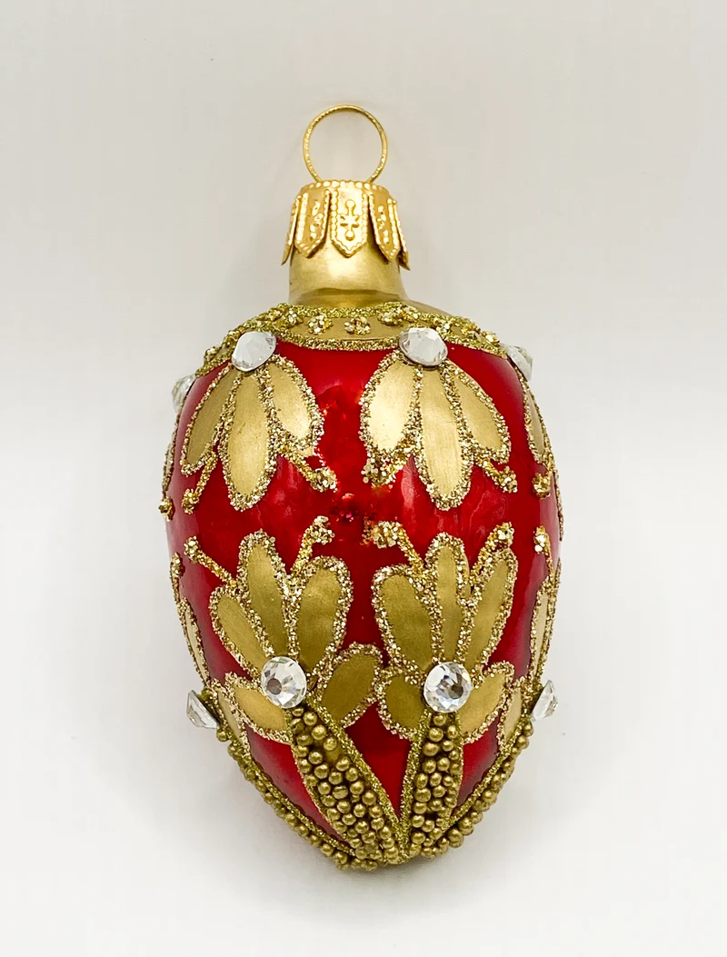 Kleines rotes Ei mit Golddekor
