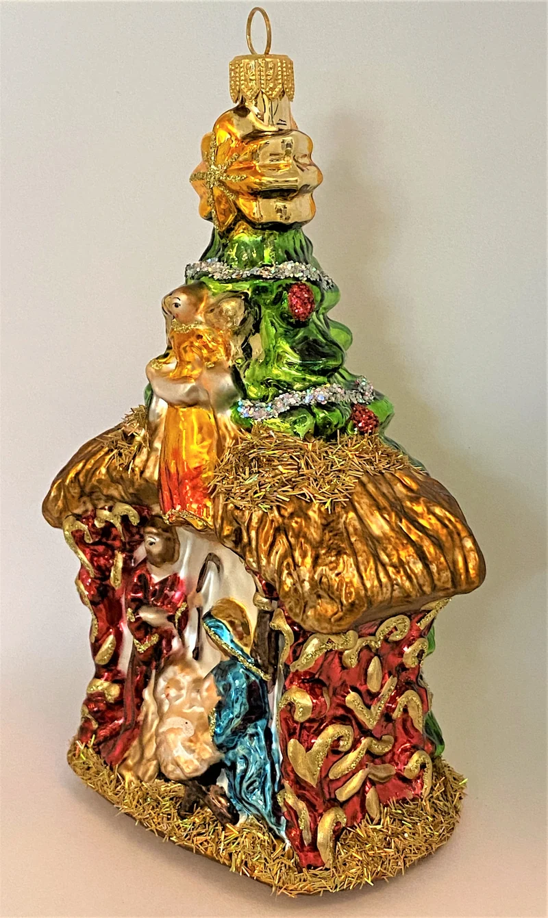 Heilige Familie in Krippe mit Engel und Stern