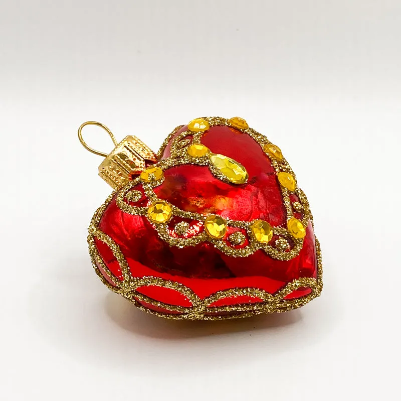 Rotes Herz mit goldenen Schmucksteinen
