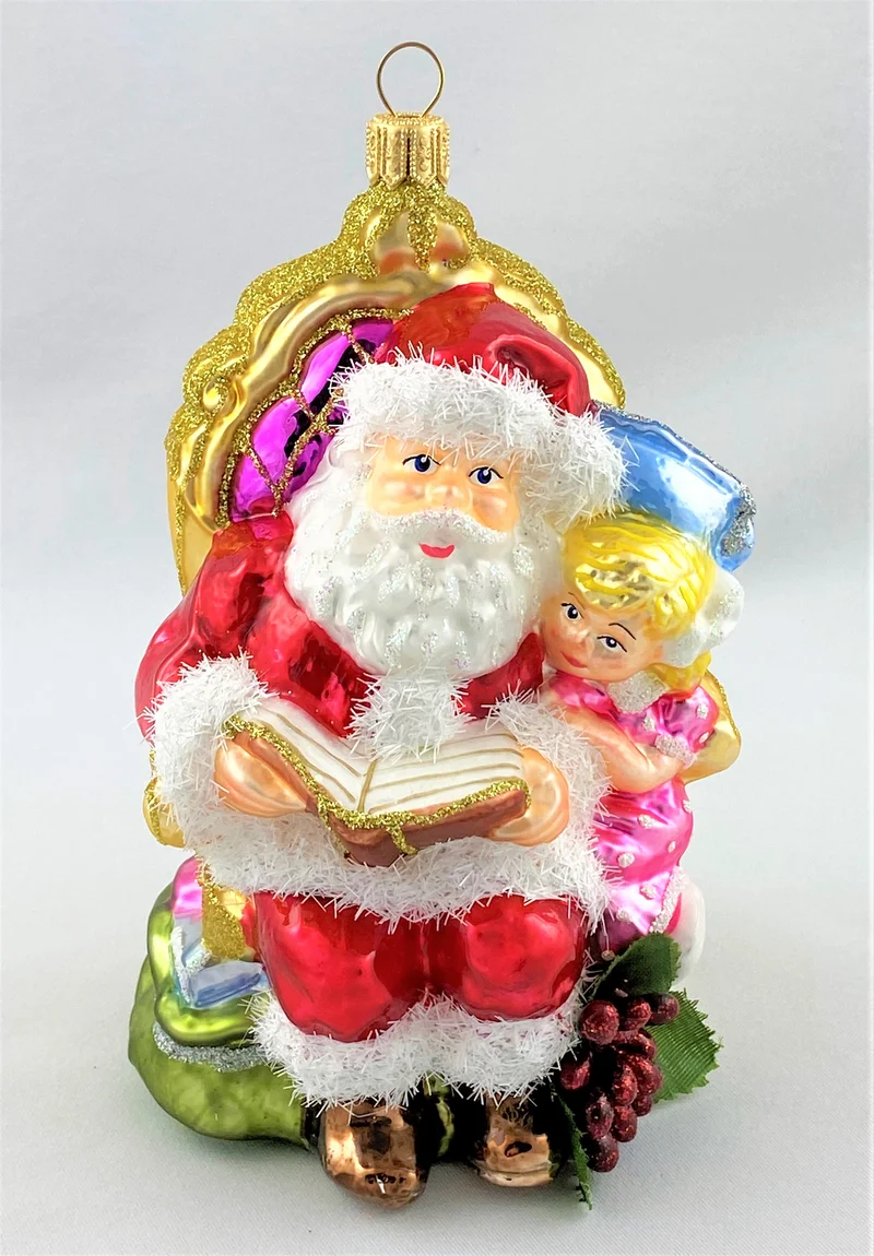 Weihnachtsmann liest dem Mädchen eine Weihnachtsgeschichte vor