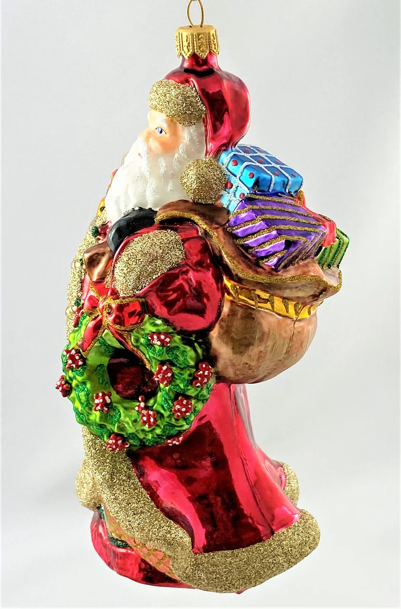 Stattlicher Weihnachtsmann mit vielen Geschenken und geschmücktem Kranz