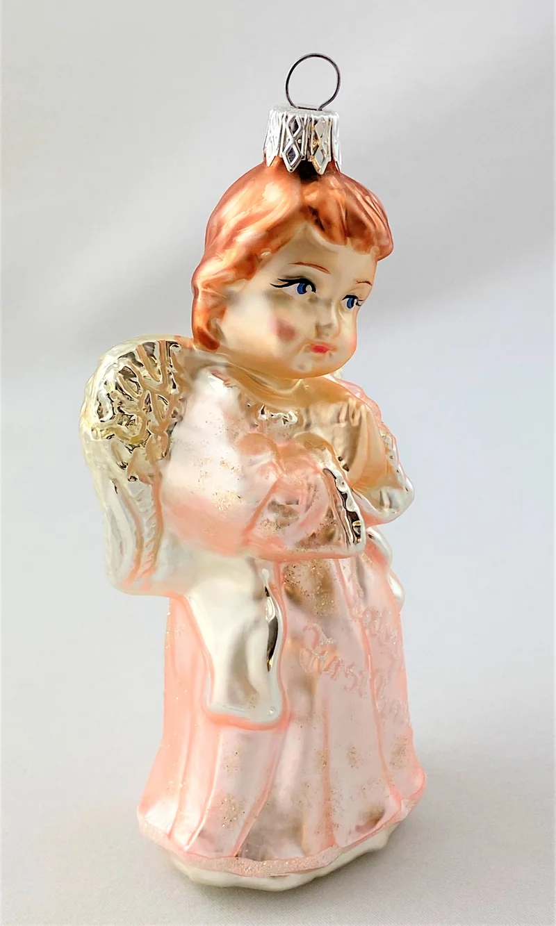 Engel im rosaroten Kleid mit der Aufschrift " Baby`s first Christmas "