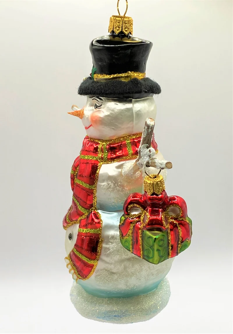 Schneemann mit rotem Schal und Hut und Geschenk