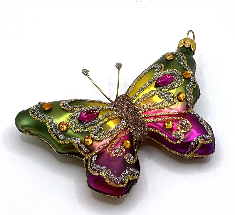 Schmetterling mit grün und pinken Flügeln mit Schmucksteinen