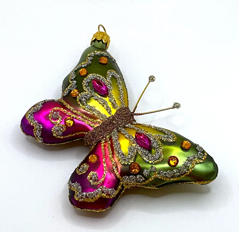 Schmetterling mit grün und pinken Flügeln mit Schmucksteinen