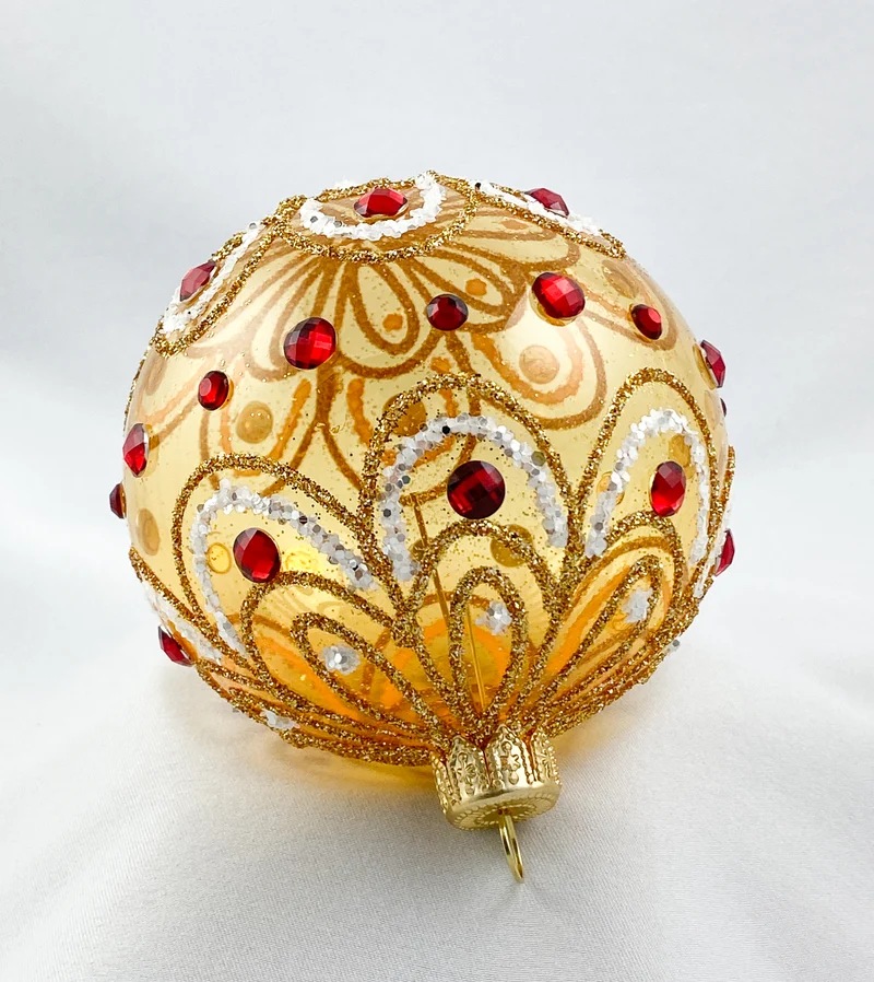 Kugel gold transparent stilisiertem Blätterdekor und roten Steinen