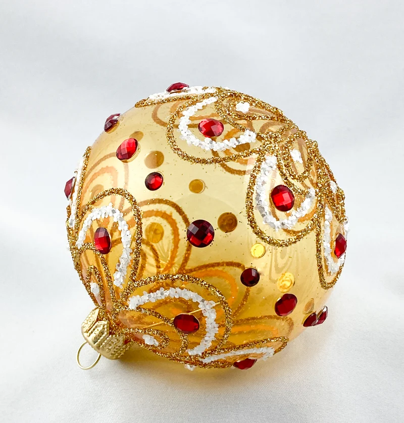 Kugel gold transparent stilisiertem Blätterdekor und roten Steinen