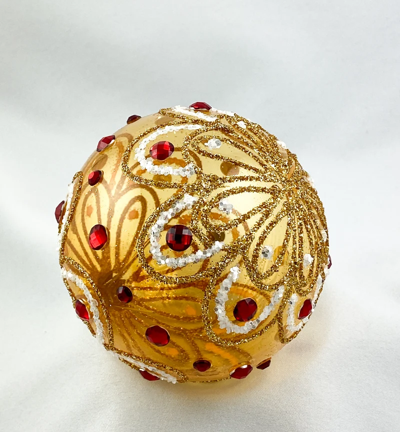 Kugel gold transparent stilisiertem Blätterdekor und roten Steinen