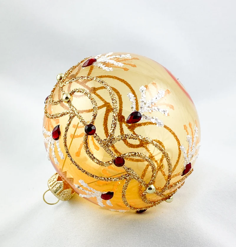 Kugel gold transparent mit Wellenmotiv und roten Steinen