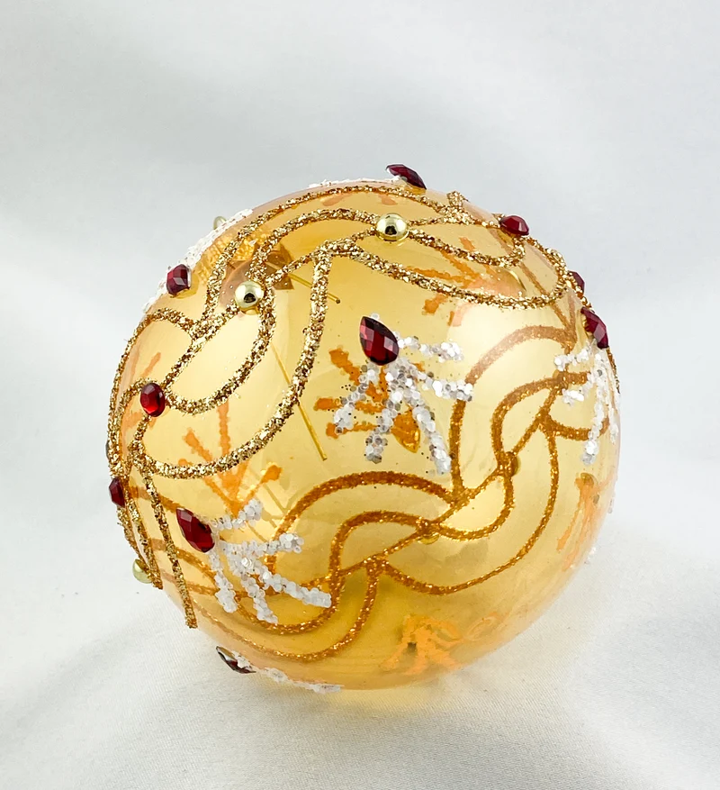 Kugel gold transparent mit Wellenmotiv und roten Steinen