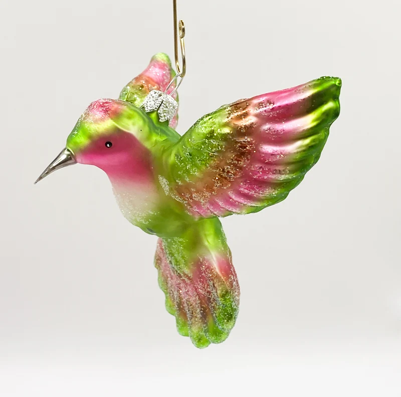 Kolibri fliegend grün und pink