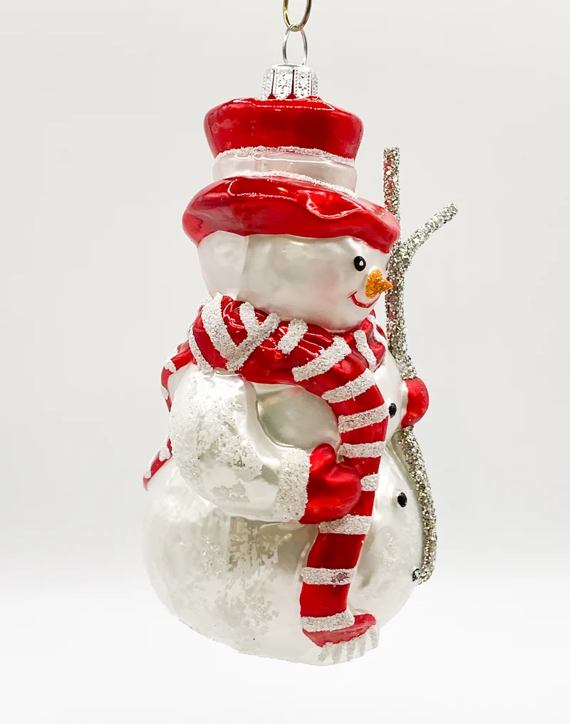 Schneemann mit rotem Schal und Reisig-Stecken