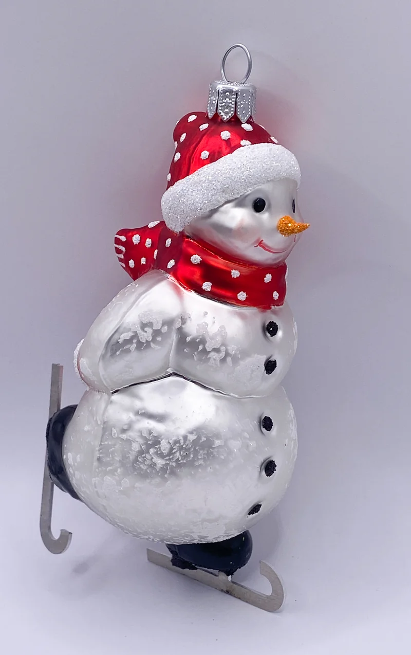 Schneemann Schlittschuh fahrend mit roter Mütze