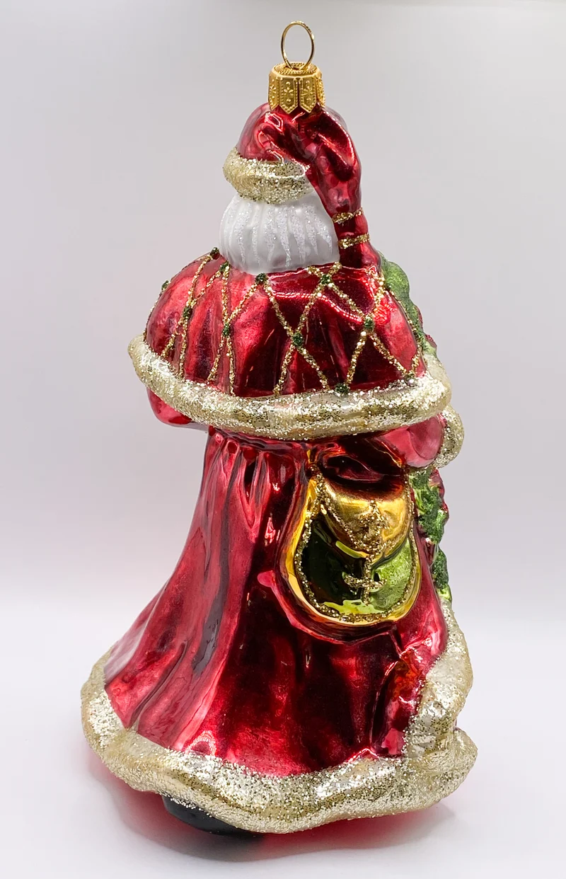 Weihnachtsmann mit Weihnachtsstern und Glocke in rotem Rock